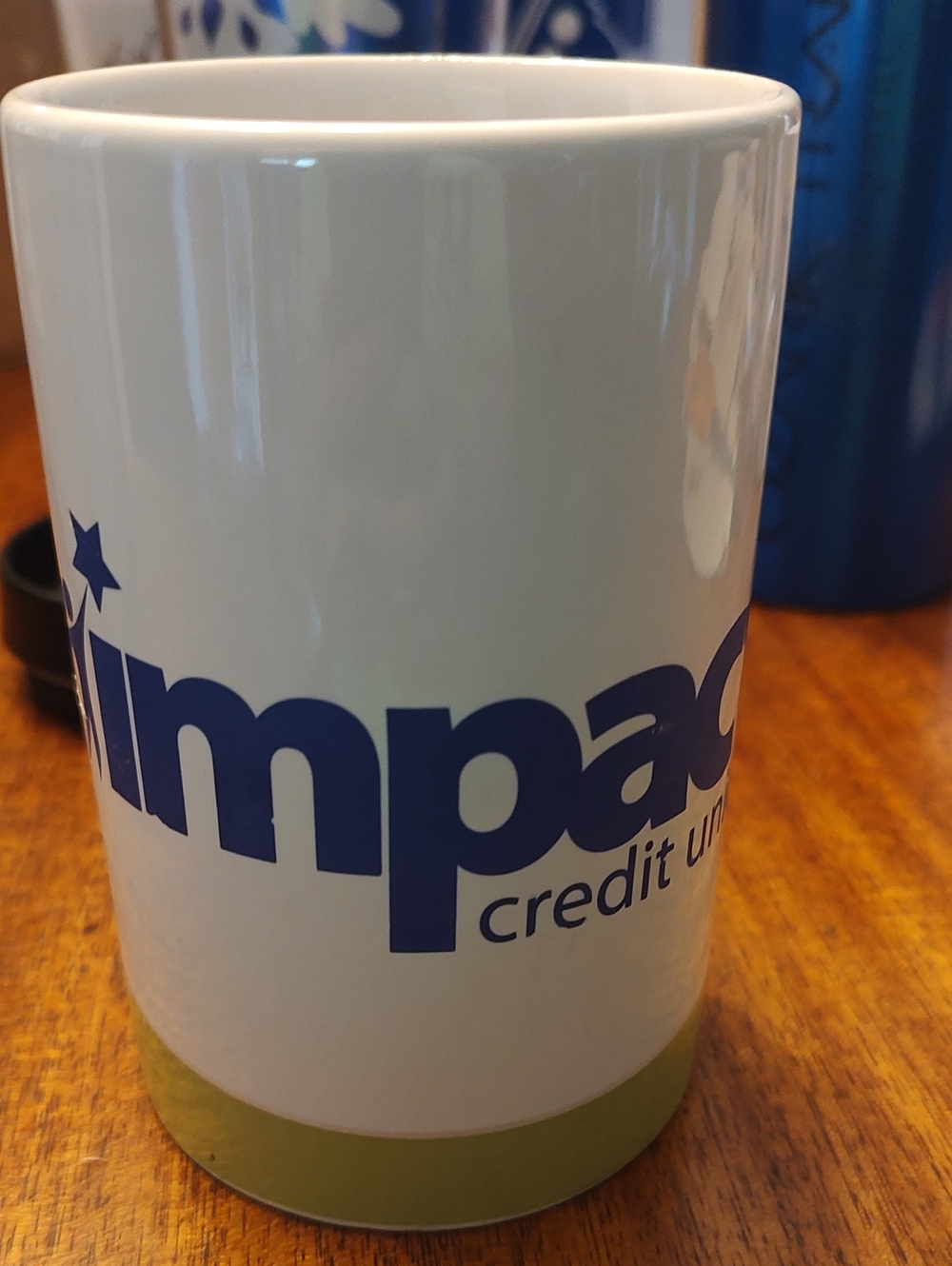Impact Credit Union Branded Coffee Mug in White and Blue with Green Accent